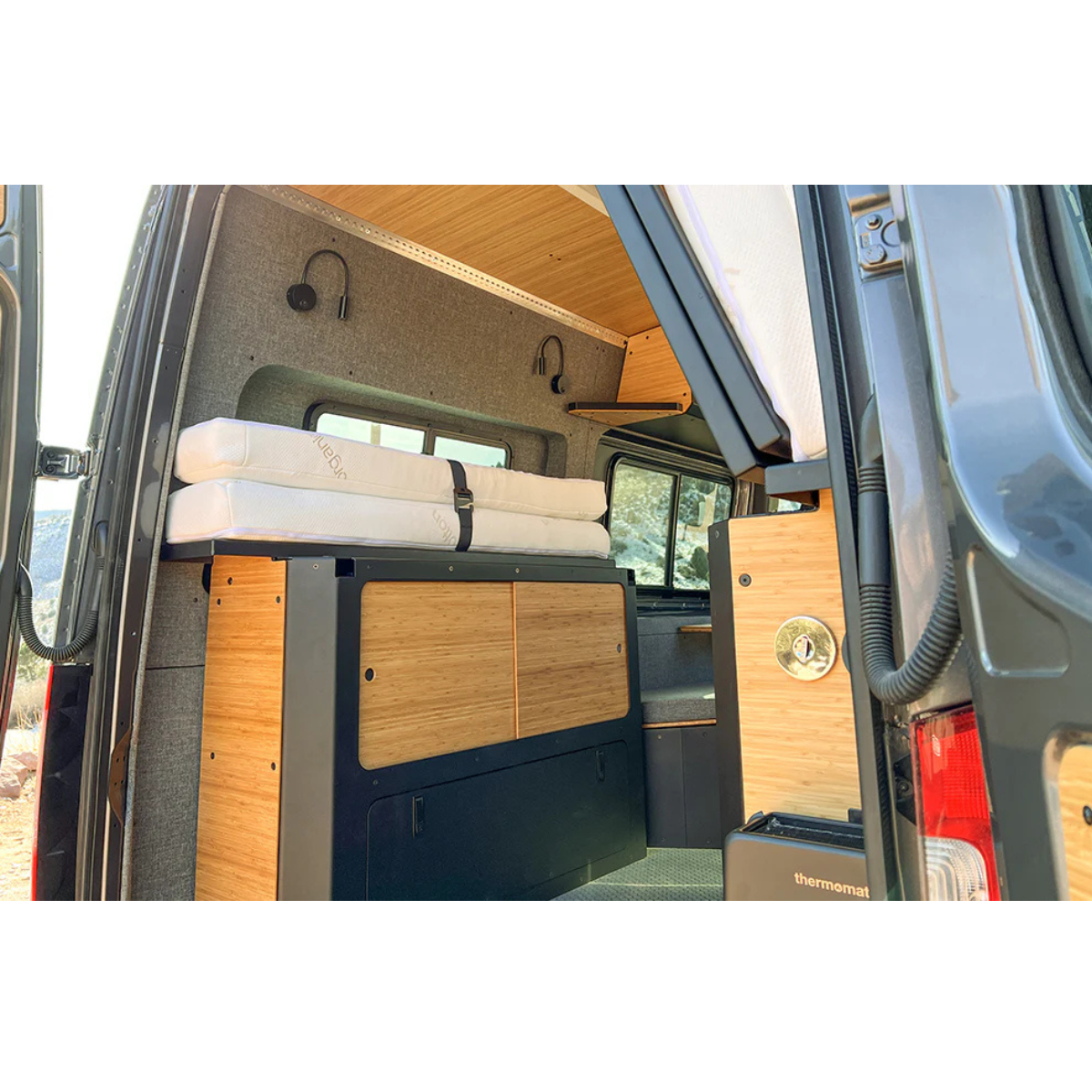 Installed murphy bed system with storage and nomad mattress folded and buckled up