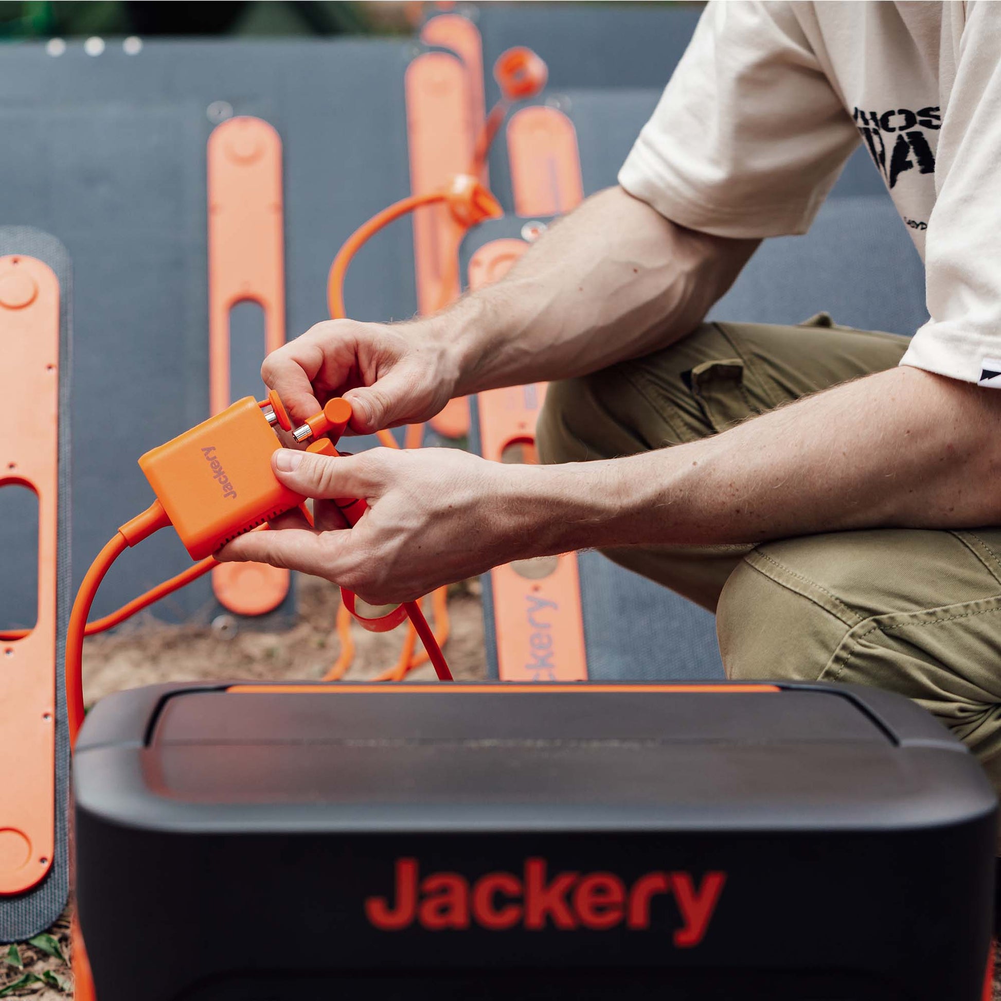 Person Plugging in Cables For Using the Power Station