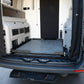 Open cargo area of a van with deck cargo