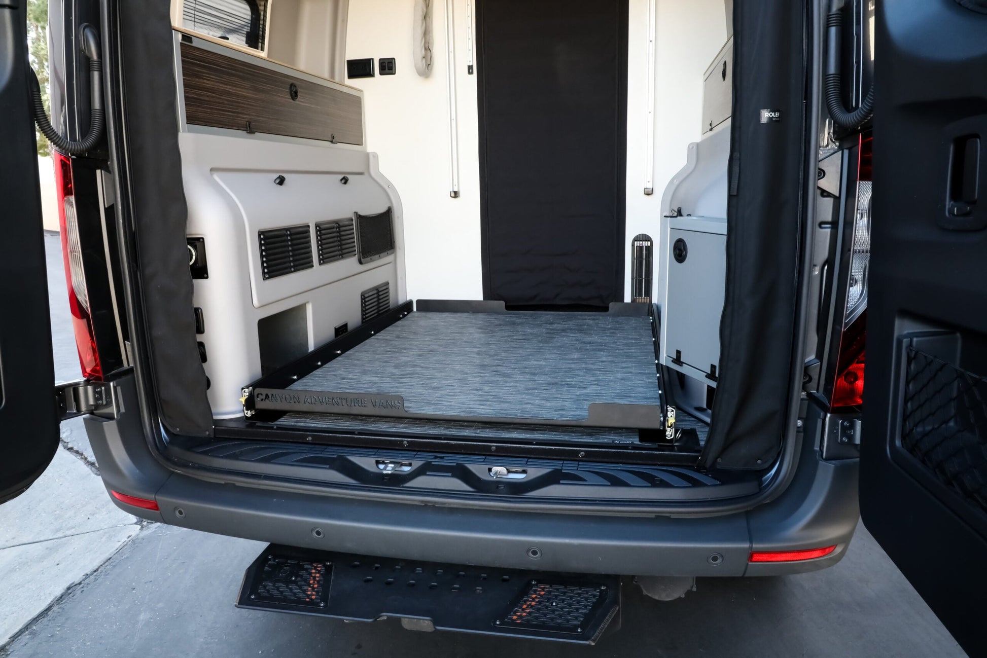 Open cargo area of a van with deck cargo