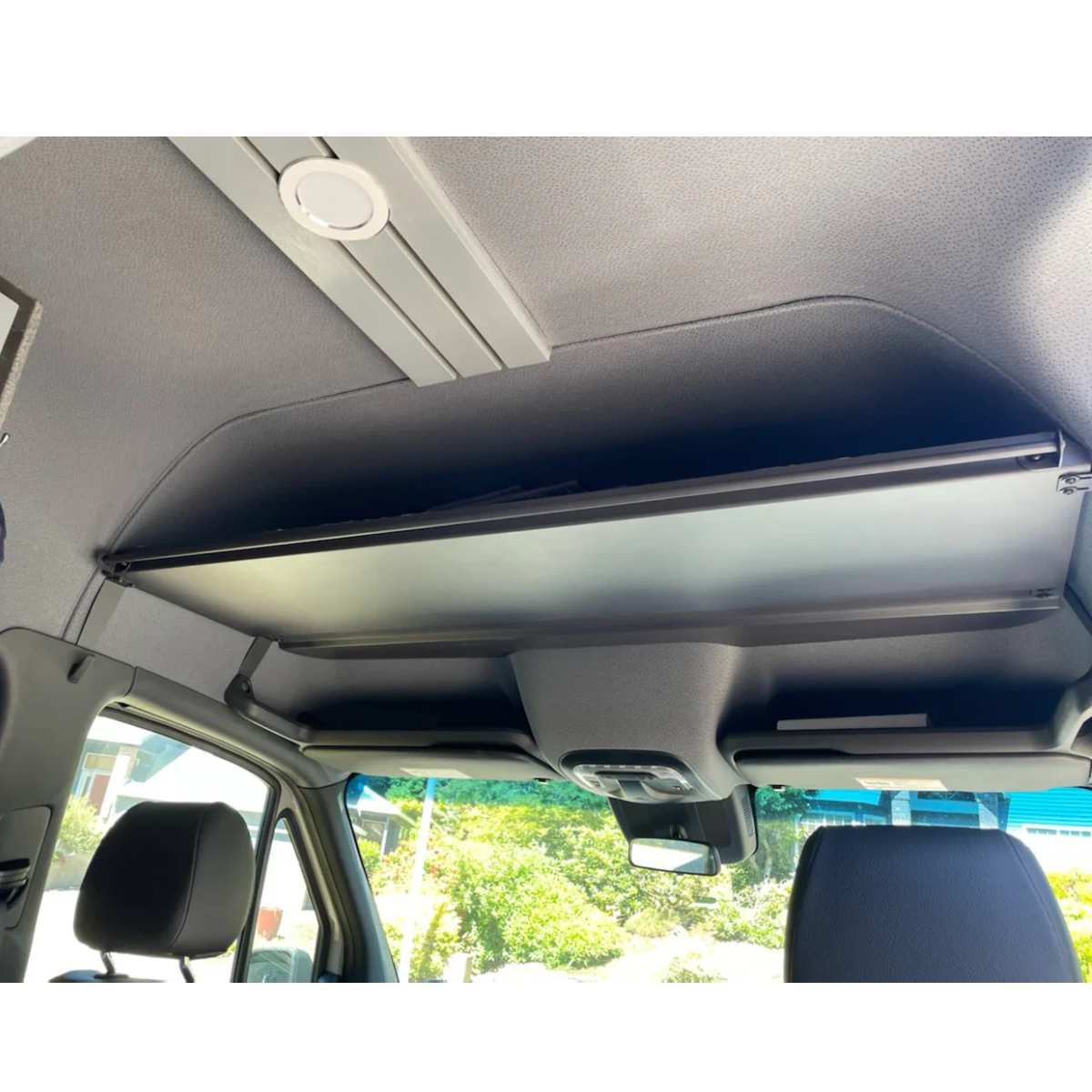 Headliner shelf with curtain rod installed