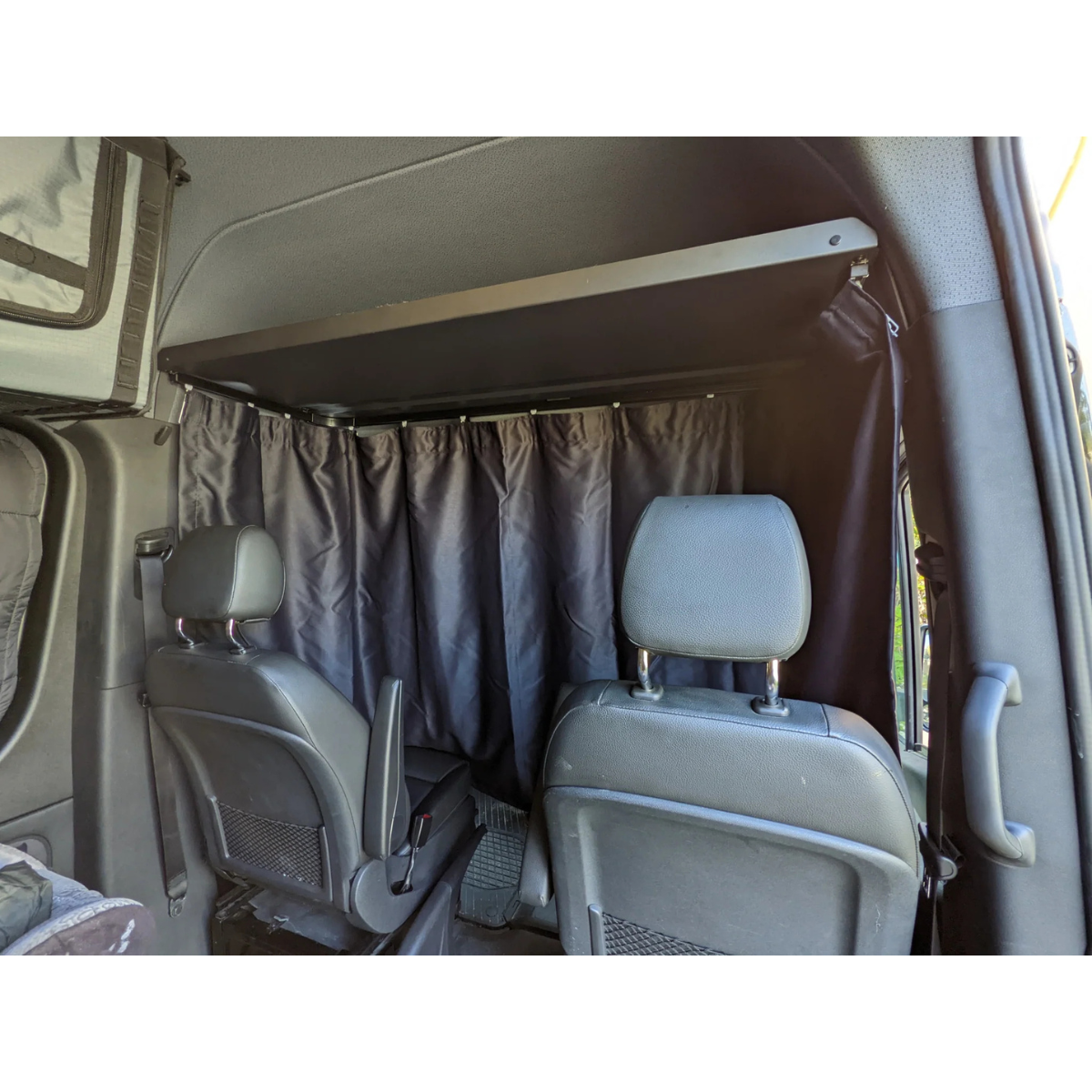 Headliner shelf with installed curtain rod and 180 blackout curtain