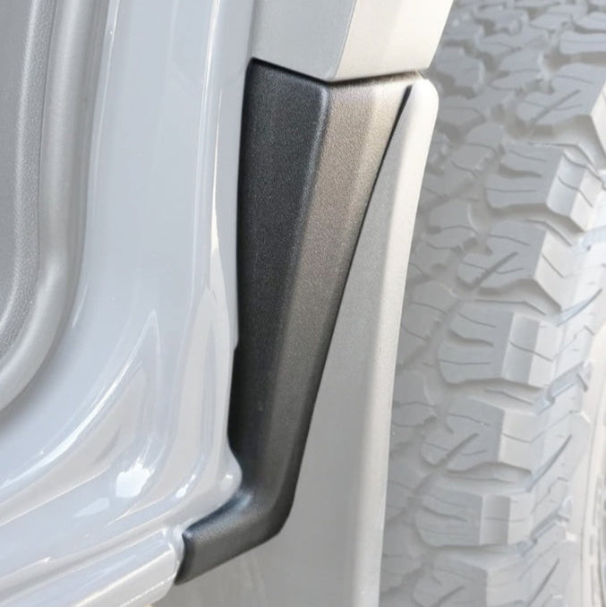 Close-up of a vehicle tire with a mud guard attached