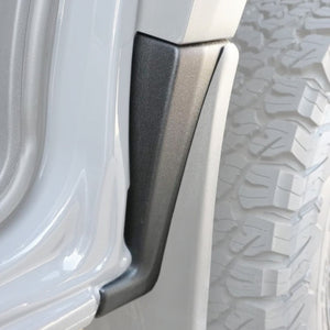 Close-up of a vehicle tire with a mud guard attached