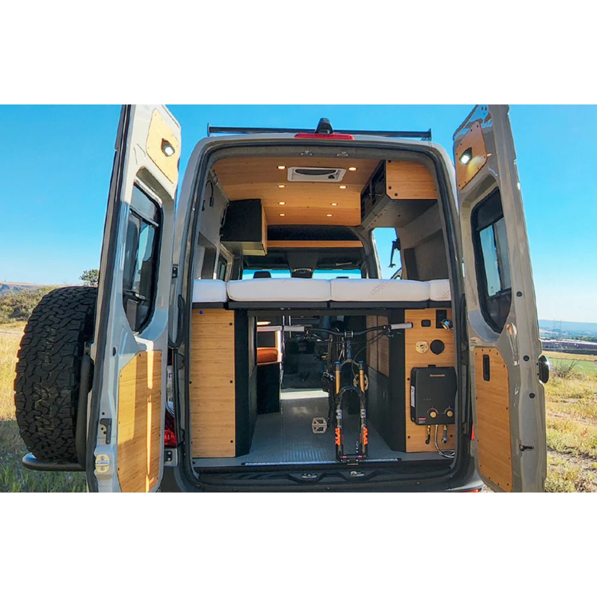 Installed Nomad Murphy Bed System with Storage in a Sprinter 144 with mountain bike underneath the bed