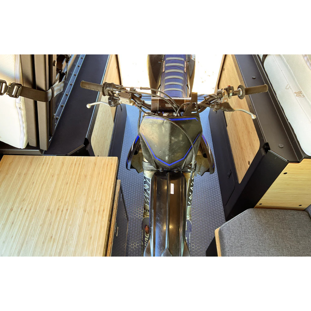Dirt bike in van with Murphy Bed system buckled up