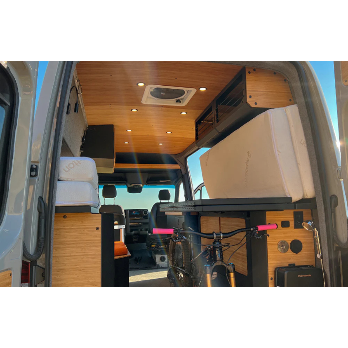 Installed Murphy Bed system in a sprinter van with a mountain bike stored under the bed