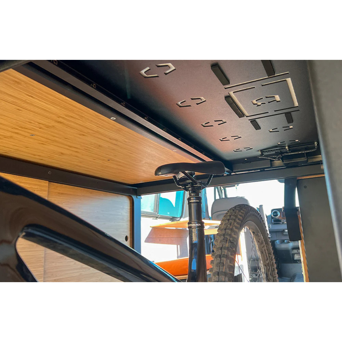 Bottom view of Murphy bed system in Sprinter van with mountain bike stored